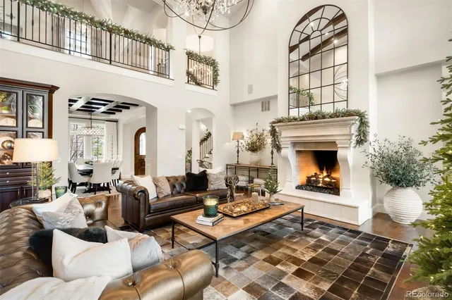 a living room with furniture a fireplace and a floor to ceiling window