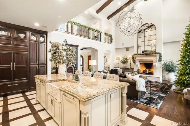 a living room with furniture large windows and flat screen tv