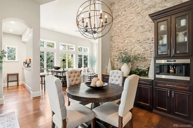 a living room with furniture and a dining table with wooden floor