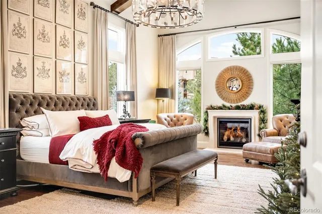 a living room with furniture a fireplace and a large window