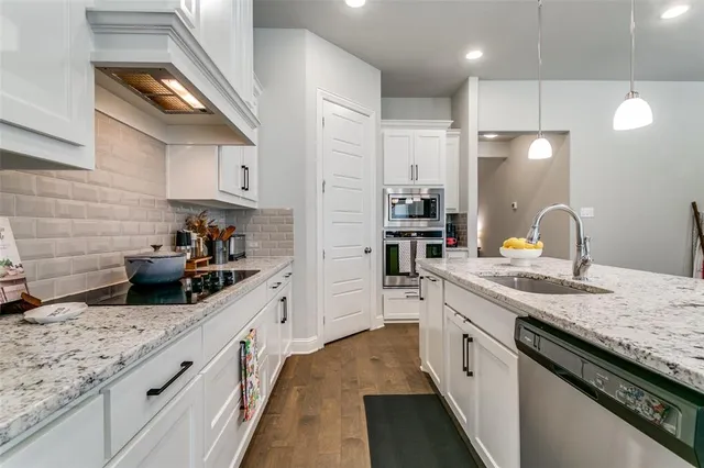 a kitchen with granite countertop stainless steel appliances and sink
