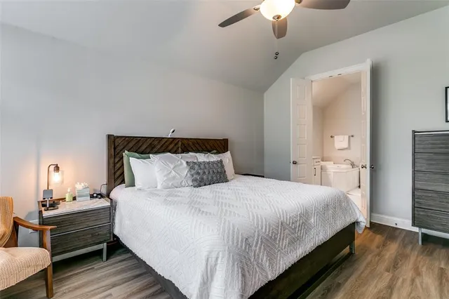 a bedroom with bed and a chandelier