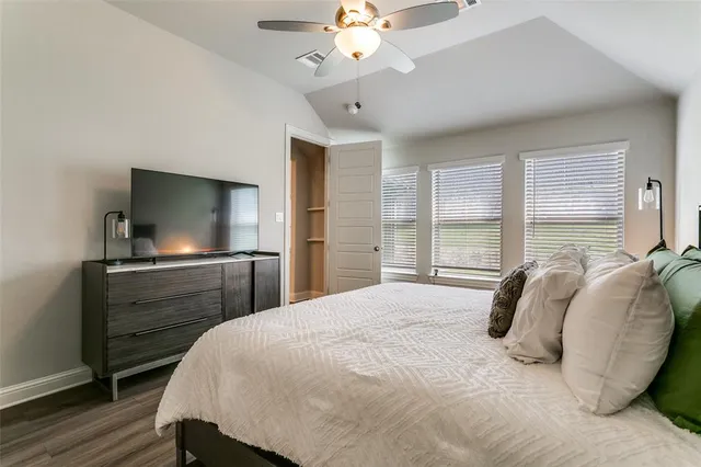 a bedroom with a bed and a flat screen tv