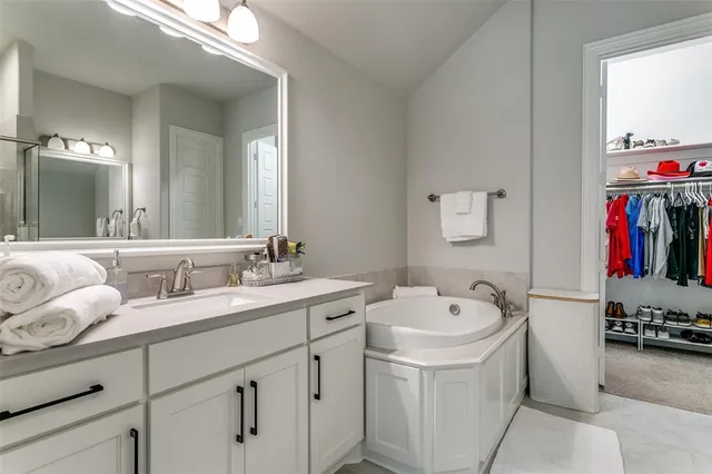 a bathroom with a sink a vanity and a mirror