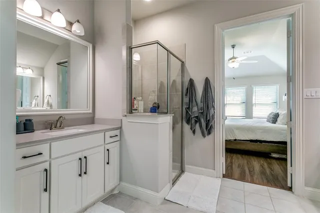 a en suite bathroom with a double vanity sink and a mirror