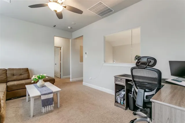 a workspace with furniture and ceiling fan