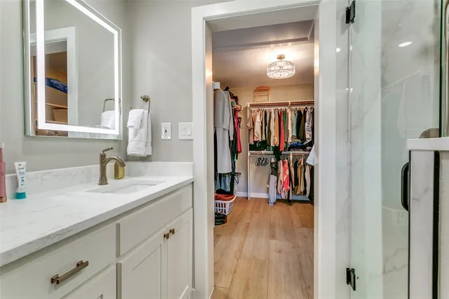 a view of a hallway with wooden floor and windows
