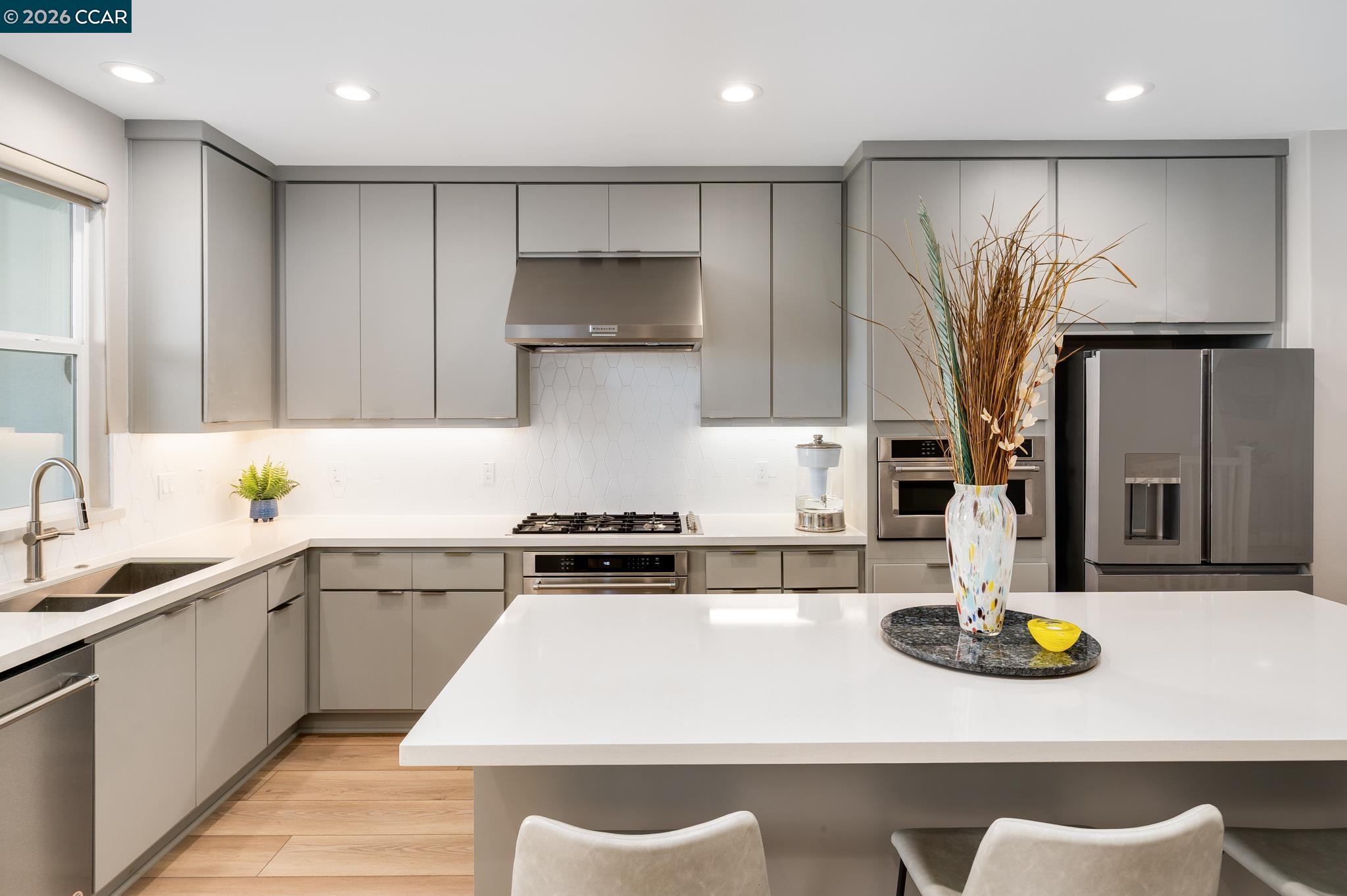 1200 Lorenzini Loop San Ramon, CA 94583 - Photo 3 of 35 a kitchen with kitchen island granite countertop a sink a stove and refrigerator