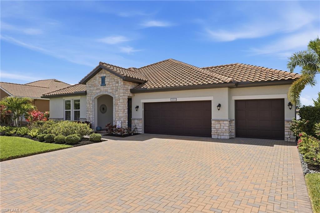 2094 Grove Drive Naples, FL 34120 - Photo 1 of 40 a front view of a house with a yard and garage