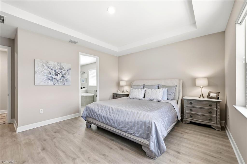 2094 Grove Drive Naples, FL 34120 - Photo 11 of 40 a bedroom with a bed and a night stand