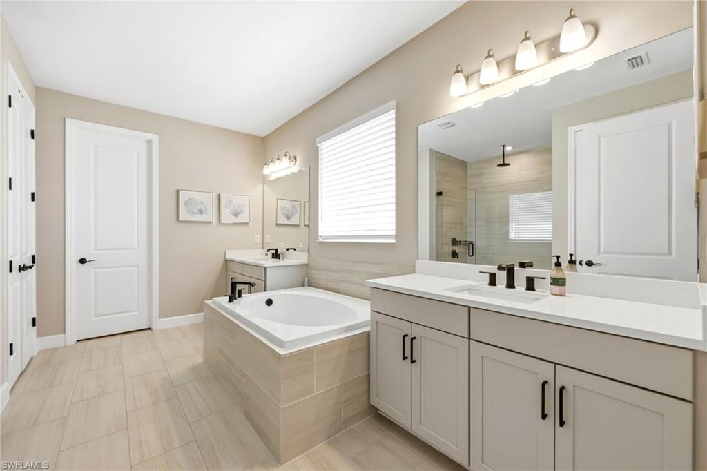 2094 Grove Drive Naples, FL 34120 - Photo 13 of 40 a bathroom with a double vanity sink mirror and