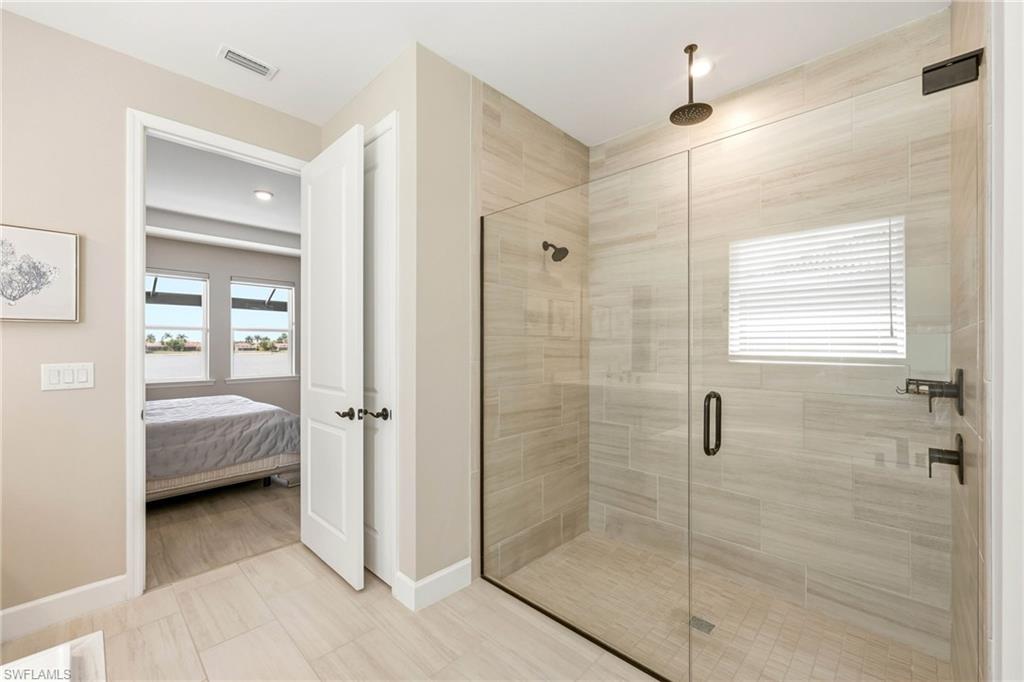 2094 Grove Drive Naples, FL 34120 - Photo 14 of 40 a en suite bathroom with a shower