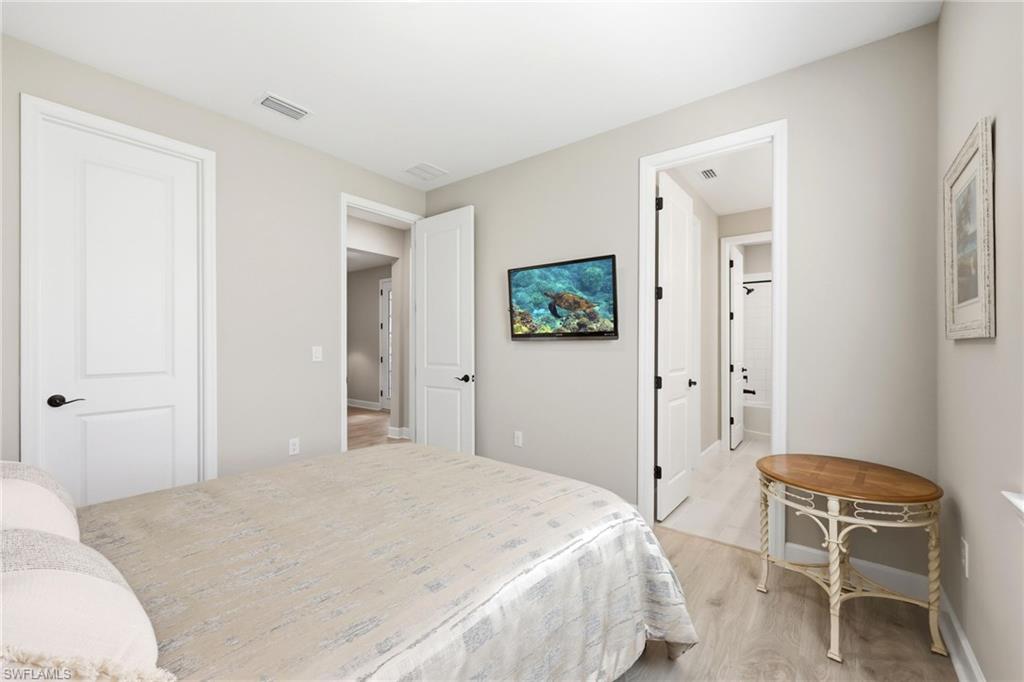 2094 Grove Drive Naples, FL 34120 - Photo 18 of 40 a bedroom with a bed and a chair