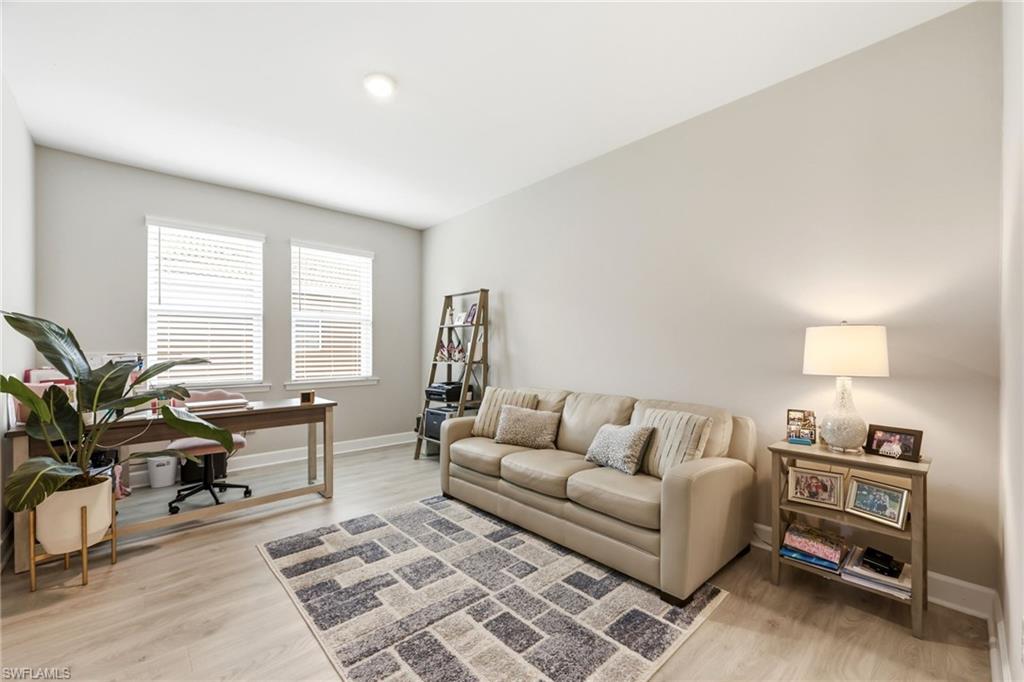 2094 Grove Drive Naples, FL 34120 - Photo 21 of 40 a living room with furniture and a flat screen tv