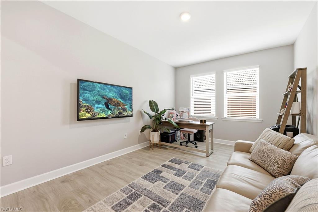 2094 Grove Drive Naples, FL 34120 - Photo 22 of 40 a living room with furniture and a flat screen tv