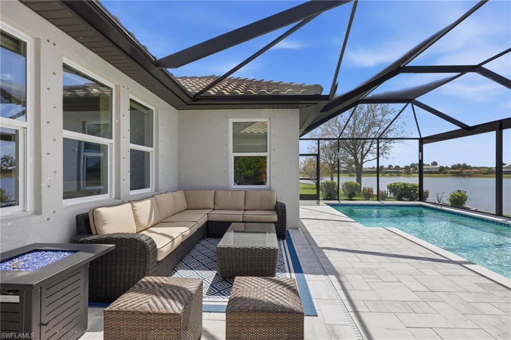 2094 Grove Drive Naples, FL 34120 - Photo 25 of 40 a view of a patio with couches and table under an umbrella