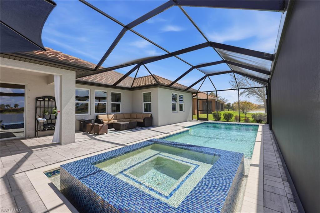 2094 Grove Drive Naples, FL 34120 - Photo 29 of 40 a view of a backyard patio with table and chairs under an umbrella