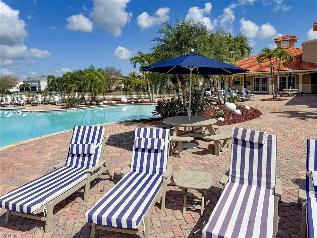 2094 Grove Drive Naples, FL 34120 - Photo 38 of 40 a view of a patio with a table chairs and a fire pit