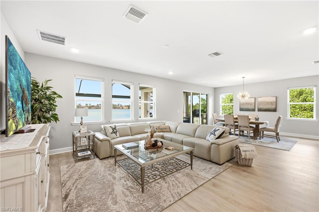 2094 Grove Drive Naples, FL 34120 - Photo 4 of 40 a living room with furniture potted plant and a large window