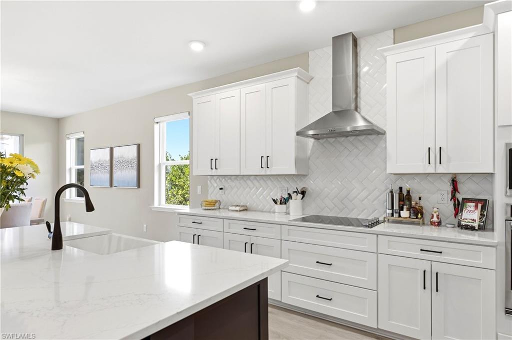 2094 Grove Drive Naples, FL 34120 - Photo 6 of 40 a kitchen with granite countertop white cabinets and a sink