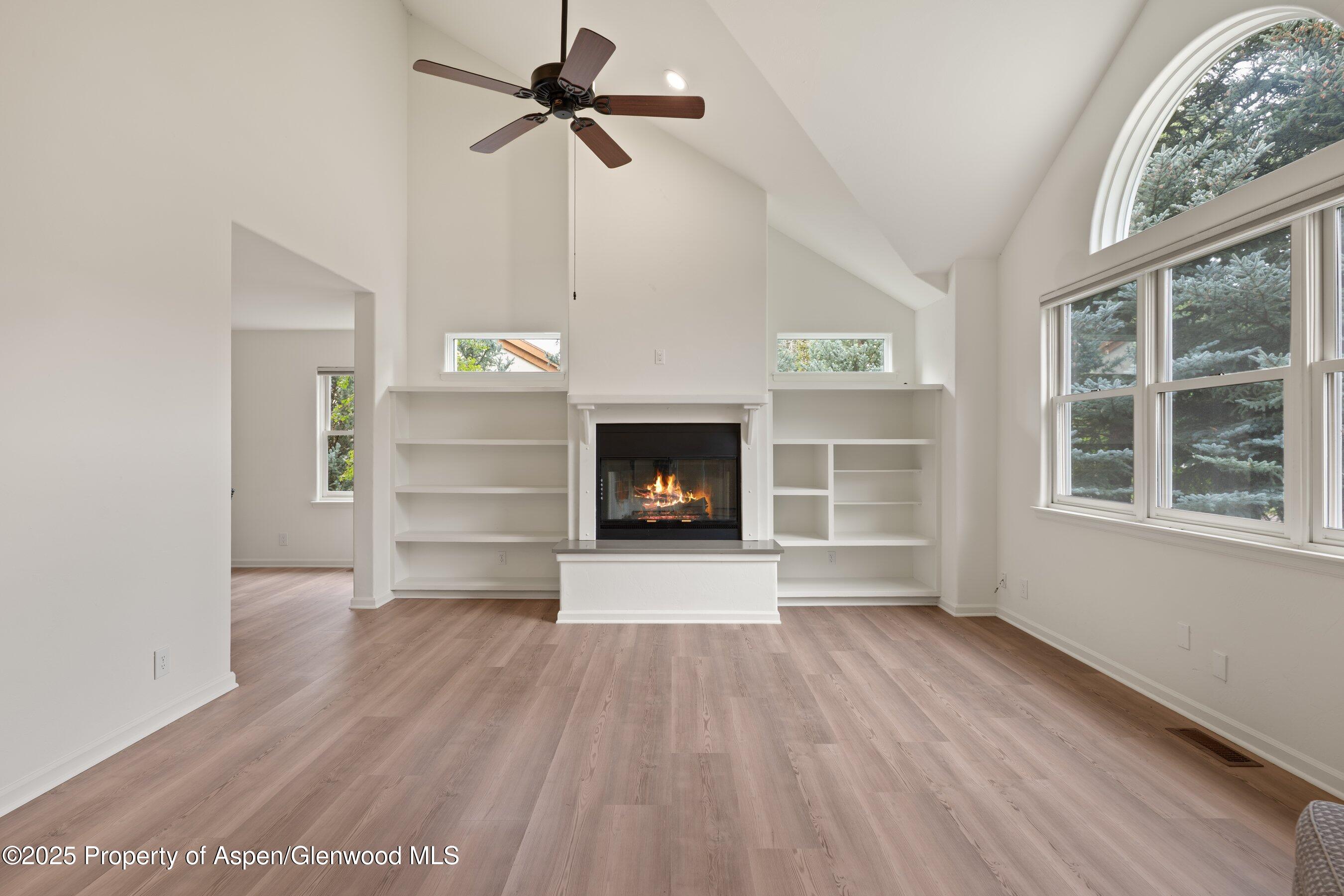 1007 Lauren Lane Basalt, CO 81621 - Photo 2 of 3 a view of an empty room with a fireplace and a window