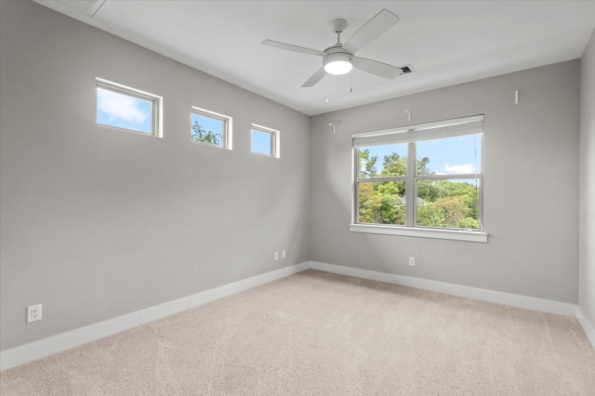 913 Stobaugh Street, Unit B Austin, TX 78757 - Photo 32 of 40 A 2nd bedroom retreat with ample natural illumination from multiple windows and a comforting ceiling fan.