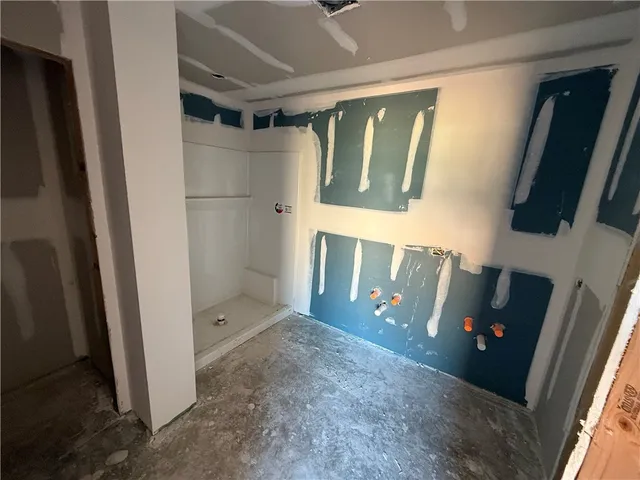 a bathroom with a glass door shower and a sink