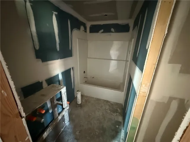 a bathroom with a tub and a shower