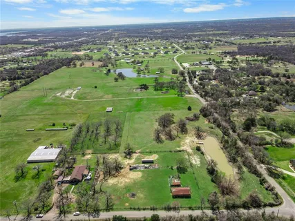 an aerial view of a houses with a yard