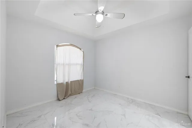 an empty room with a empty space and windows