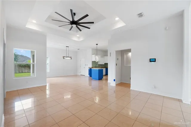 a view of a livingroom with a ceiling fan and window