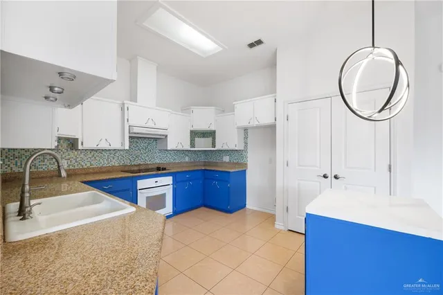 a kitchen with stainless steel appliances granite countertop a sink a stove and a microwave