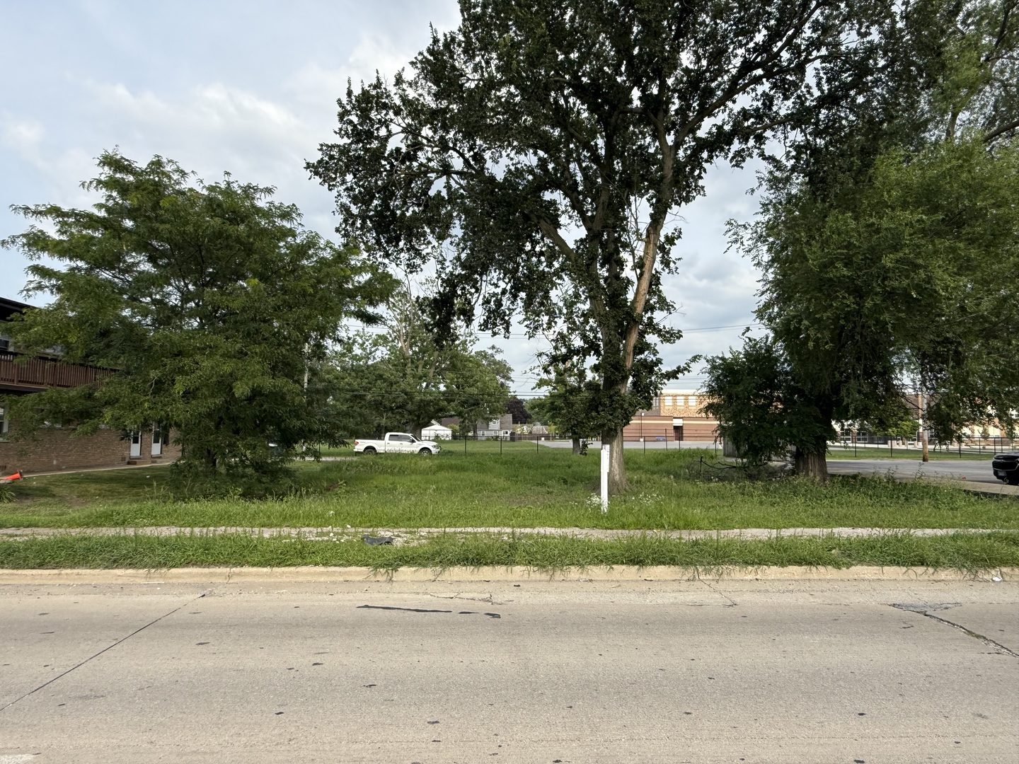 14539 Crawford Avenue Midlothian, IL 60445 - Photo 4 of 5 a green field with trees in the background