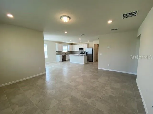 a view of a kitchen with a sink and cabinets