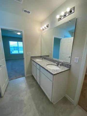 a bathroom with a glass shower door