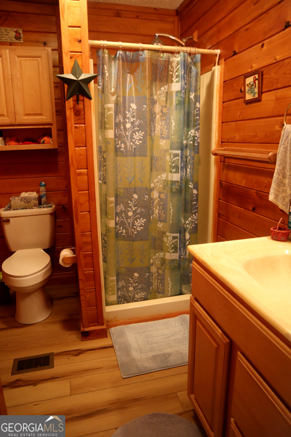 671 Pine Lake Sparta, GA 31087 - Photo 12 of 31 a bathroom with a shower and a toilet