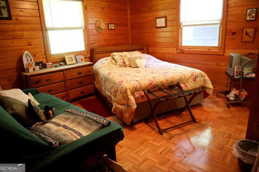 671 Pine Lake Sparta, GA 31087 - Photo 13 of 31 a bed sitting in a bedroom next to a window