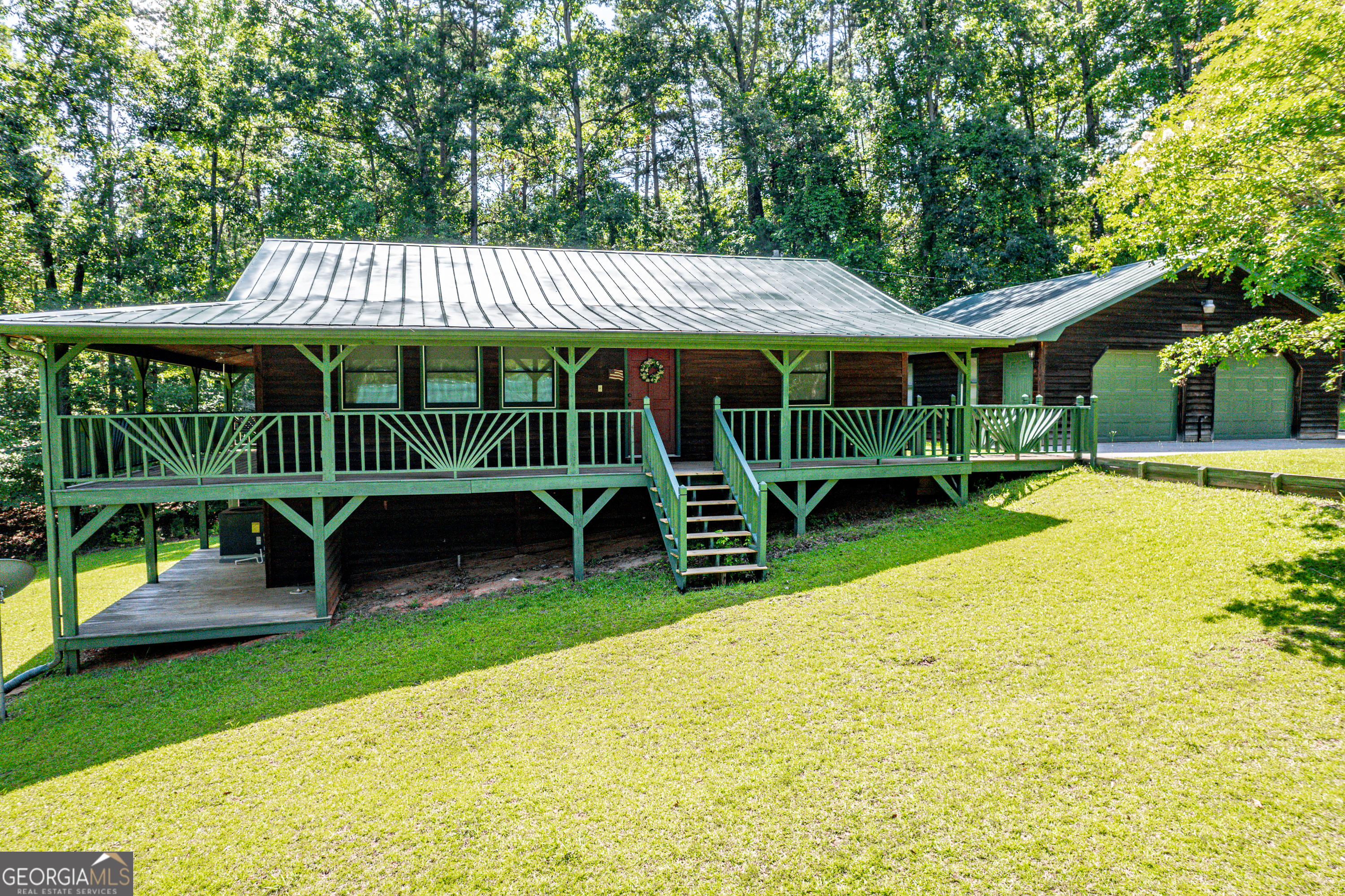 671 Pine Lake Sparta, GA 31087 - Photo 2 of 31 a view of a chair and table in backyard of the house