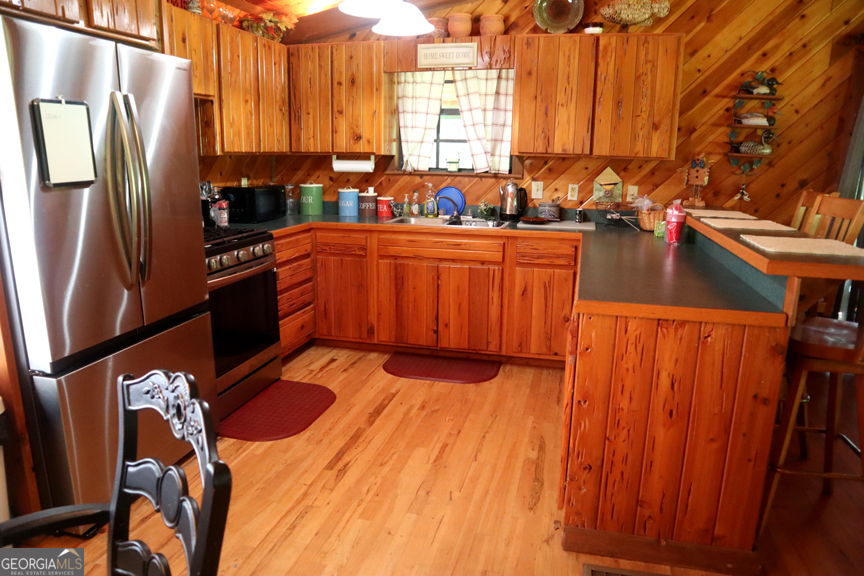 671 Pine Lake Sparta, GA 31087 - Photo 21 of 31 a kitchen with stainless steel appliances a sink a counter space and a window