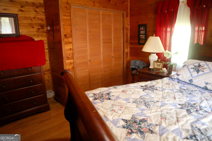 671 Pine Lake Sparta, GA 31087 - Photo 25 of 31 a bedroom with a bed and a lamp