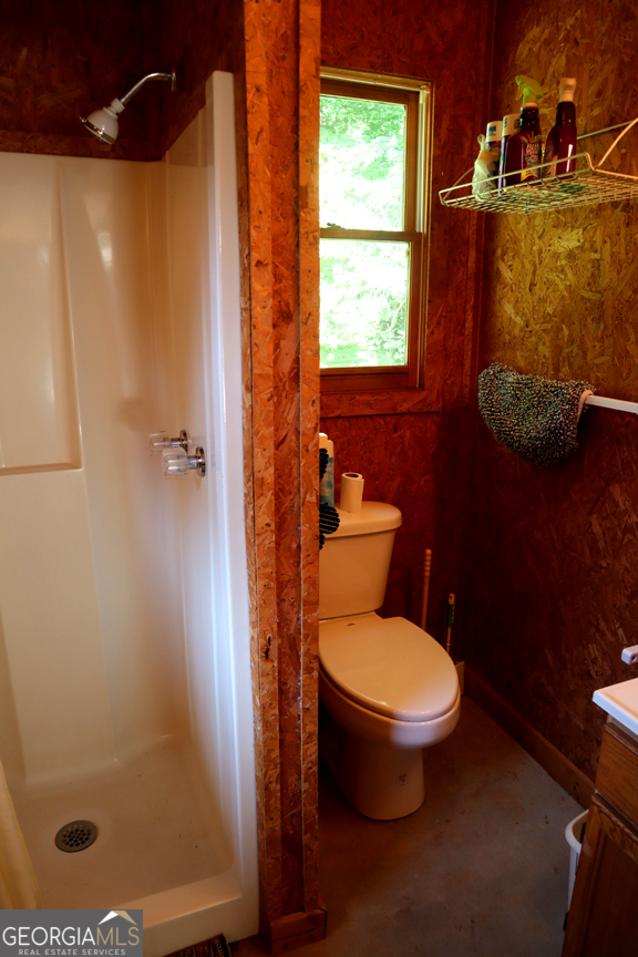 671 Pine Lake Sparta, GA 31087 - Photo 26 of 31 a bathroom with a toilet and a shower