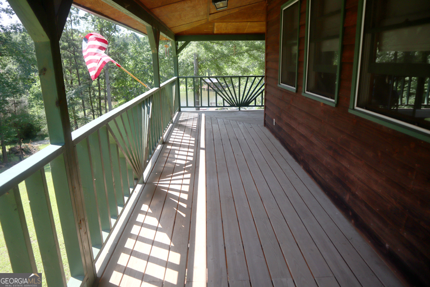 671 Pine Lake Sparta, GA 31087 - Photo 6 of 31 a view of balcony with wooden floor