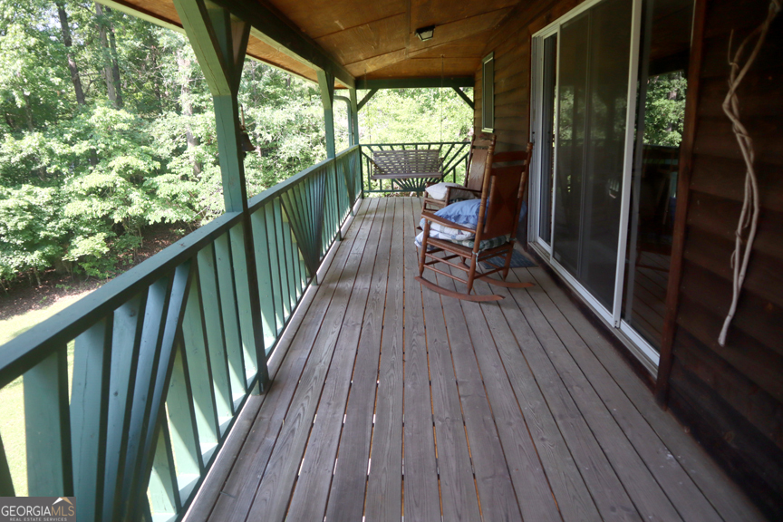 671 Pine Lake Sparta, GA 31087 - Photo 7 of 31 a view of balcony with wooden floor and outdoor seating