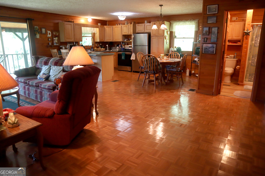671 Pine Lake Sparta, GA 31087 - Photo 9 of 31 a living room with lots of furniture and kitchen view
