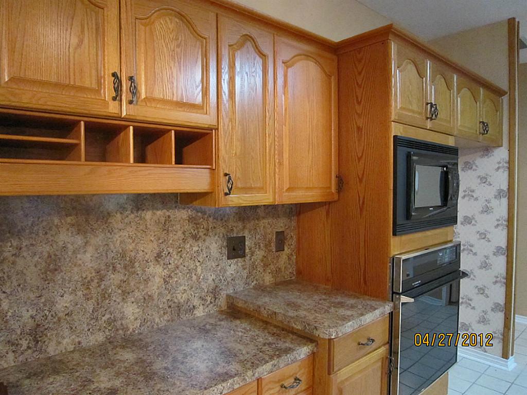 12223 A Old Huffmeister Road Cypress, TX 77429 - Photo 11 of 31 a kitchen with granite countertop a sink cabinets and stainless steel appliances