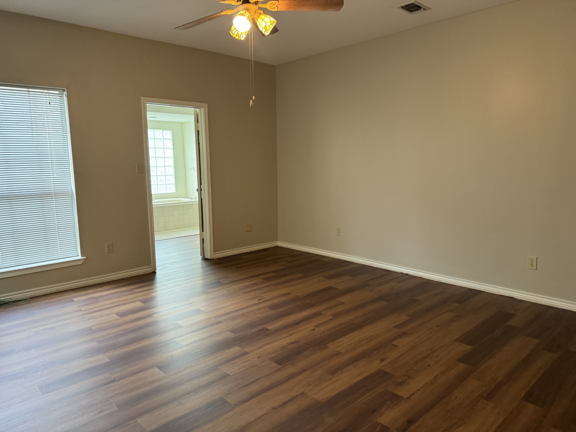 12223 A Old Huffmeister Road Cypress, TX 77429 - Photo 22 of 31 a view of an empty room with wooden floor and a window