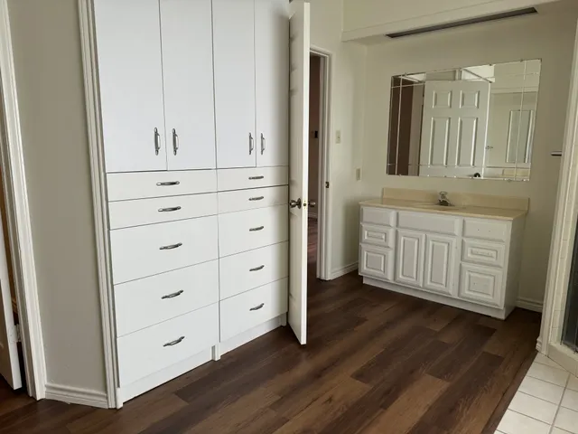 a bathroom with a double vanity sink and mirror