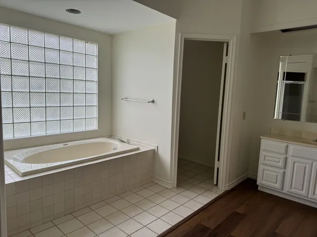 a spacious bathroom with a bathtub and a shower