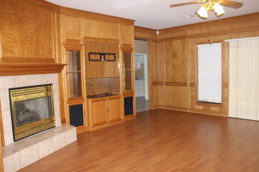 12223 A Old Huffmeister Road Cypress, TX 77429 - Photo 5 of 31 an empty room with wooden floor fireplace and windows