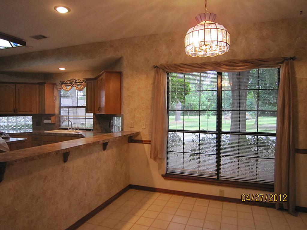 12223 A Old Huffmeister Road Cypress, TX 77429 - Photo 7 of 31 a view of a kitchen with a sink wooden floor and a chandelier